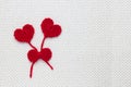 Love affair, love story. Two red crochet wool hearts and ribbon on white crochet background. The concept for 14 February, romantic