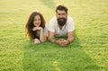 Love is in the air. Bearded man and sensual girl relax on green grass. Couple in love on summer landscape. Enjoying Royalty Free Stock Photo