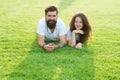 Love is in the air. Bearded man and sensual girl relax on green grass. Couple in love on summer landscape. Enjoying Royalty Free Stock Photo