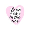 Love is in the air lettering card with pink heart. Greeting Valentine`s day typography text. Romantic quote, love celebration fon Royalty Free Stock Photo