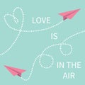 Love is in the air Lettering text. Two pink flying origami paper plane. Royalty Free Stock Photo