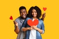 Love in the air. Romantic black lovers with red hearts in hands Royalty Free Stock Photo