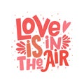 `Love is in the air` vector lettering clip art isolated on white background. Handwritten poster or greeting card. Royalty Free Stock Photo