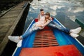 Love is all that matters. Top view of beautiful young couple taking selfie using smart phone while lying in the boat Royalty Free Stock Photo
