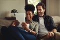 A love that is all mine. a happy young couple using a digital tablet while relaxing on a couch in their living room at Royalty Free Stock Photo