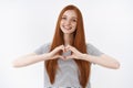 Love all you need. Charming romantic charismatic redhead passionate girl blue eyes show heart gesture confessing