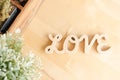 LOVE alphabets of wooden letters on the light wood background, top view. Love and Valentine`s day concept