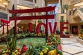 The Love Art Sculpture in the waterfall atrium at The Venetian Resort and Hotel with lush green trees and plants, colorful flowers Royalty Free Stock Photo