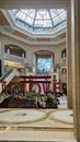 The Love Art Sculpture in the waterfall atrium at The Venetian Resort and Hotel with lush green trees and plants, colorful flowers Royalty Free Stock Photo