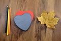 Love autumn dectoration with paper heart and acorn leave on wood