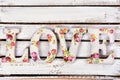 love background with decoupage decorated letters with rose pattern