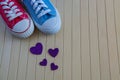 Love background with different sneakers and purple hearts