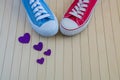 Love background with different sneakers and purple hearts