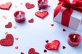Love background: Valentines day red hearts, romantic gift box, candle on white table. Romantic message template with copy space Royalty Free Stock Photo