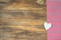 Love background with wooden heart on rustic red checkered fabric. Royalty Free Stock Photo