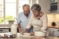 We love baking together. a senior couple baking together at home.