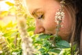 Love for Basil. A woman smells a basil plant