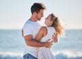 Love, beach hug and couple smile together at the ocean for peace, relax in nature and romance vacation happiness. Happy Royalty Free Stock Photo