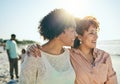 Love, beach and mother with her adult daughter walking by the ocean together while on vacation. Happy, smile and mature Royalty Free Stock Photo