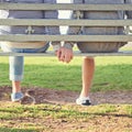 Love is a beautiful thing. Rearview shot of a young gay couple sitting together on a park bench. Royalty Free Stock Photo