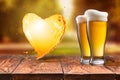 Love beer. Beer in glass with heart splash on wooden table again Royalty Free Stock Photo