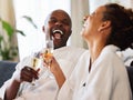 Love, black couple and celebrate with champagne, for vacation, honeymoon and anniversary happy together. Happiness, man