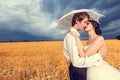 In love bride and groom in wheat field with blue sky in the back Royalty Free Stock Photo