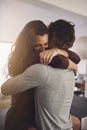 Love brings out the best in people. an affectionate young couple hugging in the kitchen at home.