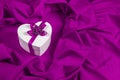 Love card with heart on a purple fabric Royalty Free Stock Photo