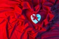 Love card with heart on a red fabric Royalty Free Stock Photo