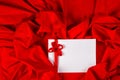 Love card with heart and ribbon on a red fabric Royalty Free Stock Photo