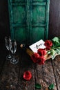 Love card, red roses and champagne bottle with glasses on shabby table, valentines Royalty Free Stock Photo