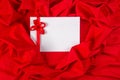 Love card with ribbon on a red fabric Royalty Free Stock Photo