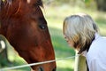 Love and care between lady and pet horse