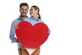 In love casual couple holding a big red heart Royalty Free Stock Photo