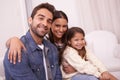 Love is at the centre of their home. Portrait of a happy young family sitting together at home. Royalty Free Stock Photo