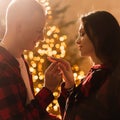 Love, christmas, couple, proposal and people concept - happy man giving diamond engagement ring to woman at home Royalty Free Stock Photo