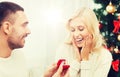 Man giving woman engagement ring for christmas Royalty Free Stock Photo