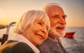 In love. Close up portrait of a beautiful and happy senior couple hugging, relaxing and smiling while sailing together Royalty Free Stock Photo