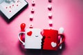 Love at coffe time, Valentine`s day concept, two mugs forming a couple of lovers kissing each other, against a red backdrop on a s Royalty Free Stock Photo