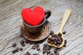 Love coffee concept - Heart in wooden coffee cup with coffee beans romantic love valentines day on wood background Royalty Free Stock Photo