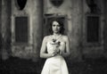 Love on the cold stones - bride stands with a wedding bouquet in Royalty Free Stock Photo