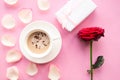 Love composition - coffee cup, gift box and red rose on pink background, top view.