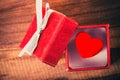 Love concept. Decorative red heart in nice red gift box on wooden background Royalty Free Stock Photo