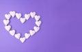 Love concept idea with big heart made from small white hearts on a purple background with copy space. Creative flat lay Royalty Free Stock Photo