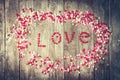 Love concept with letters LOVE and sweethearts on old wooden background, vintage toning. Top view with copy space Royalty Free Stock Photo