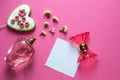 Love concept - pink adorable perfume, gingerbread heart, lipstick, flowers on pink background. Copy space for text. Woman make up Royalty Free Stock Photo