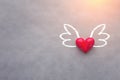Love concept with red heart object with wings drawing on grey ba Royalty Free Stock Photo