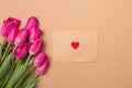 Love concept. Spring mood. Spring beige background with spring pink flowers and craft envelope with red heart. Free Royalty Free Stock Photo