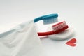 Love concept of toothbrushes, red and blue totbrushes lie in bed, also erotic missionary position intercourse metaphor